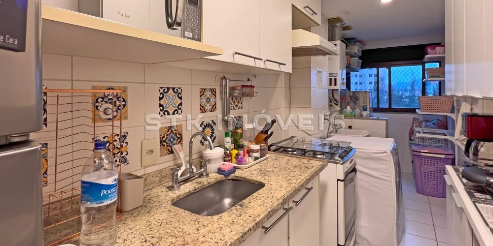 a kitchen with white cabinets and white counter tops