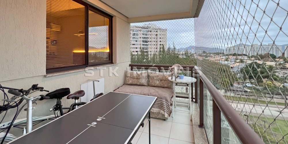 a balcony with a table and chairs